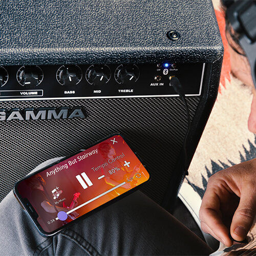 GAMMA G50 Guitar Amplifier along with someone using a tuning app on a smartphone