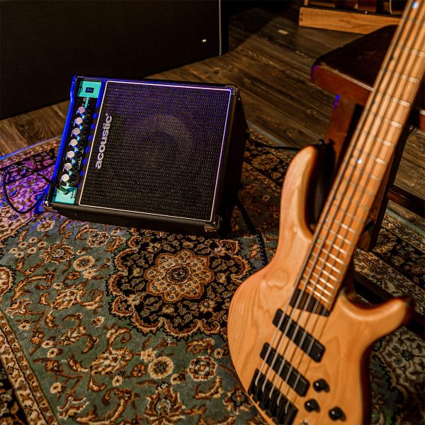 B25C combo bass amp and bass guitar leaning into a stool