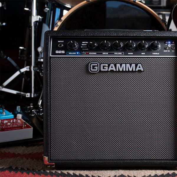 GAMMA G25 electric guitar amp on stage in front of drums and guitar pedals
