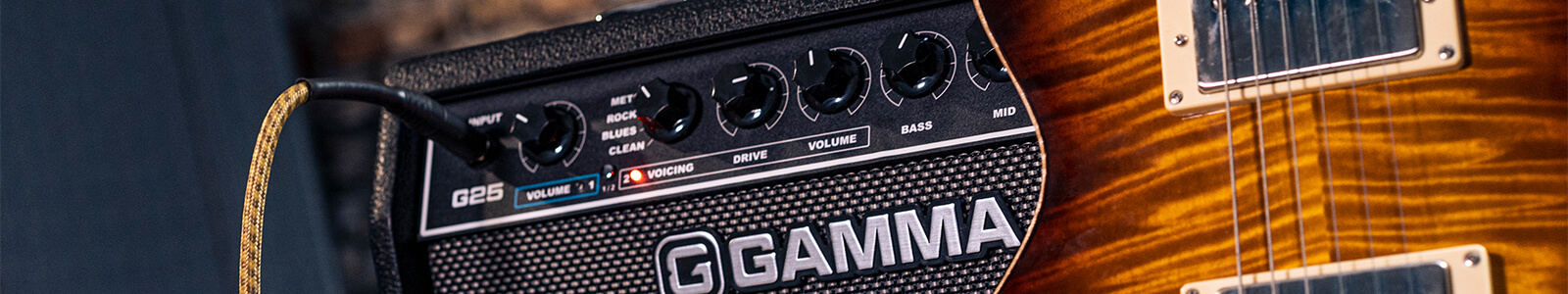 GAMMA G25 guitar amp control panel next to guitar