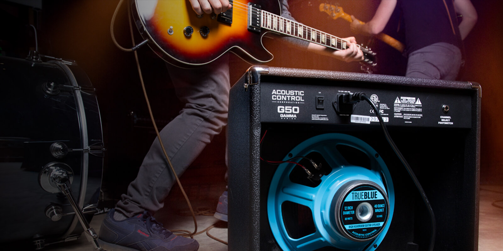 GAMMA G50 guitar amp on stage with performing band. The back of the amp is exposed, showing the bright blue 12