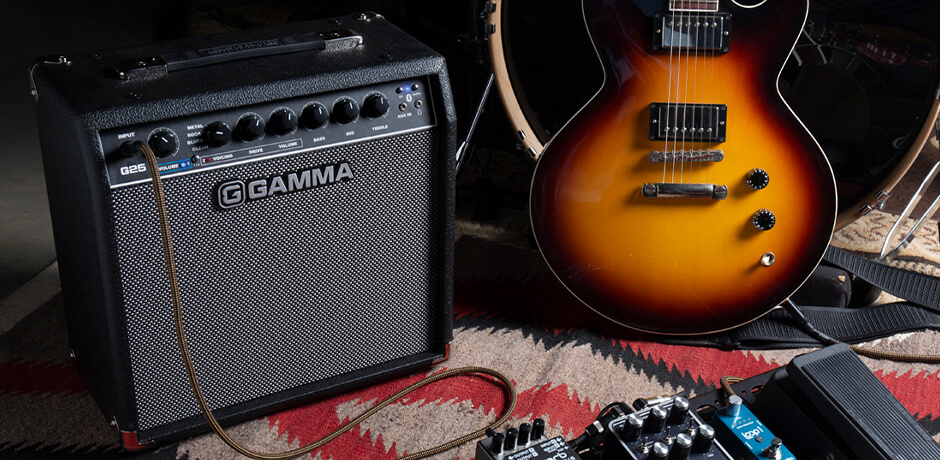 GAMMA G25 guitar amp next to drums, guitar, and pedal board