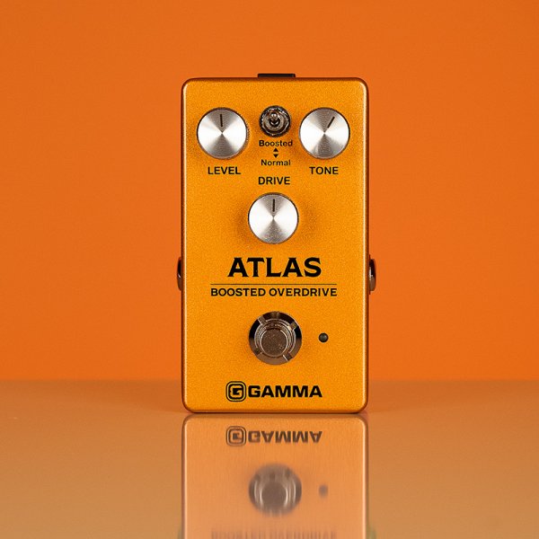 Gamma Atlas boosted overdrive pedal standing in orange space.