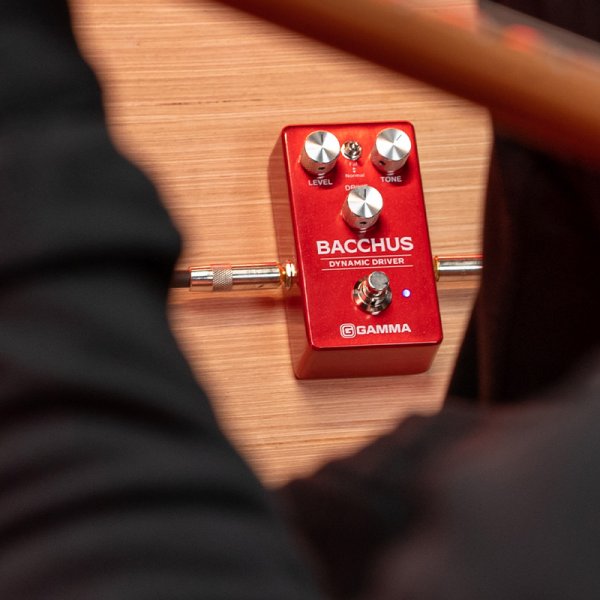Gamma Bacchus dynamic drive pedal on the floor with guitar player.