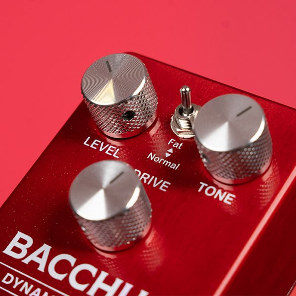 Gamma Bacchus dynamic driver pedal angled left on red background knob close up.