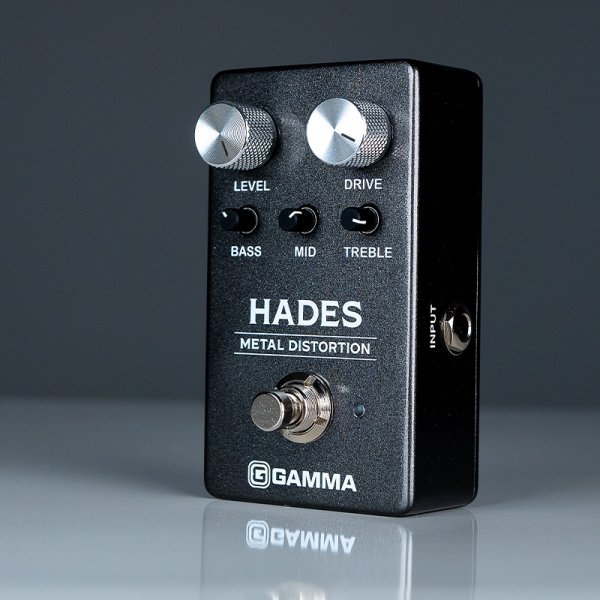 Gamma Hades metal distortion pedal in dark space standing left on the table.