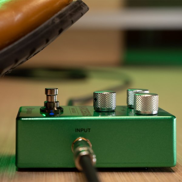 Gamma Narcissus warm delay pedal on the floor with a foot about to step on.