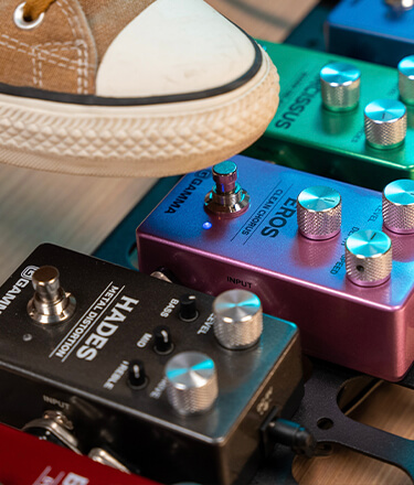 guitarist shoe tapping Gamma Eros clean chorus guitar effects pedal on pedal board next to Narcissus warm delay pedal and Hades Metal Distortion pedal